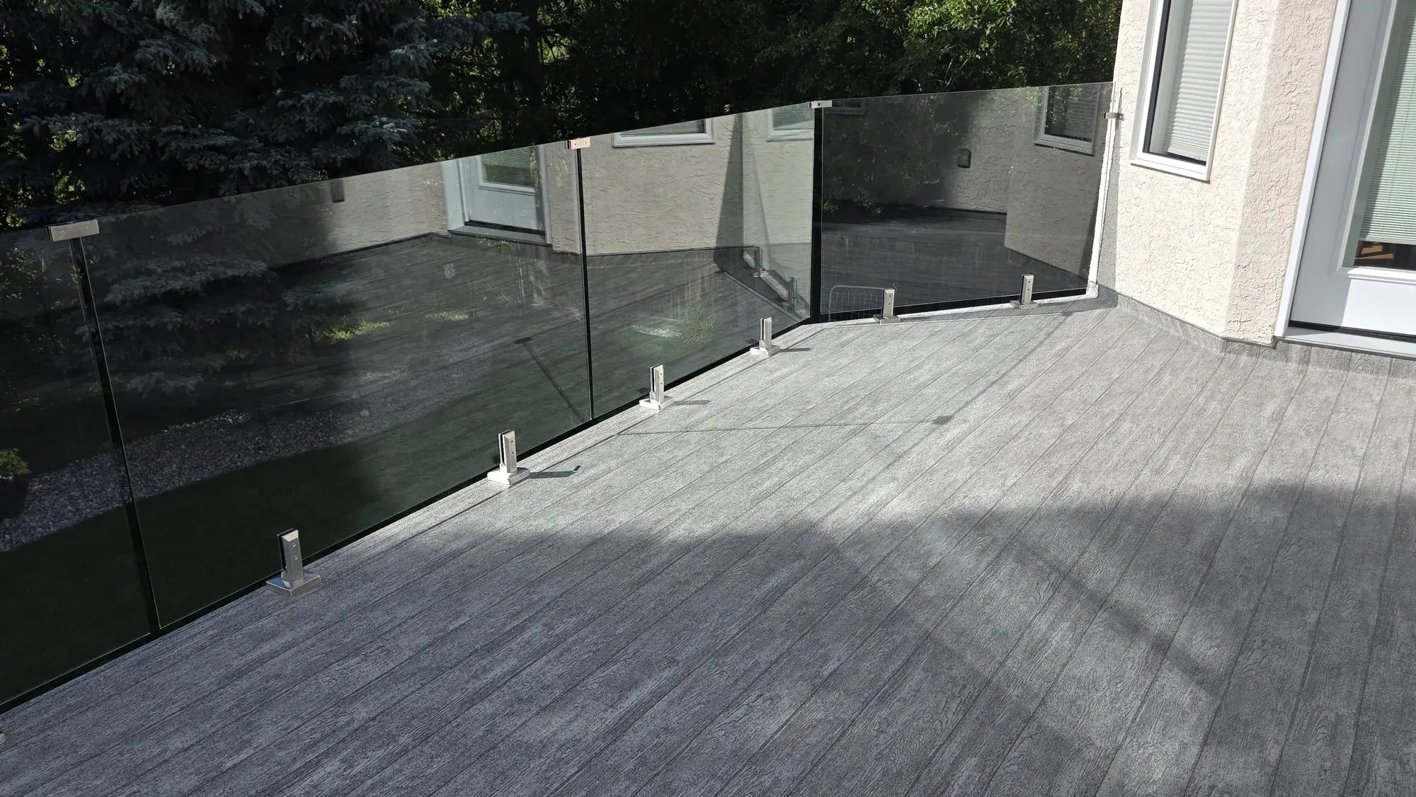 Finished woodgrain vinyl deck surface, welded seam running across it