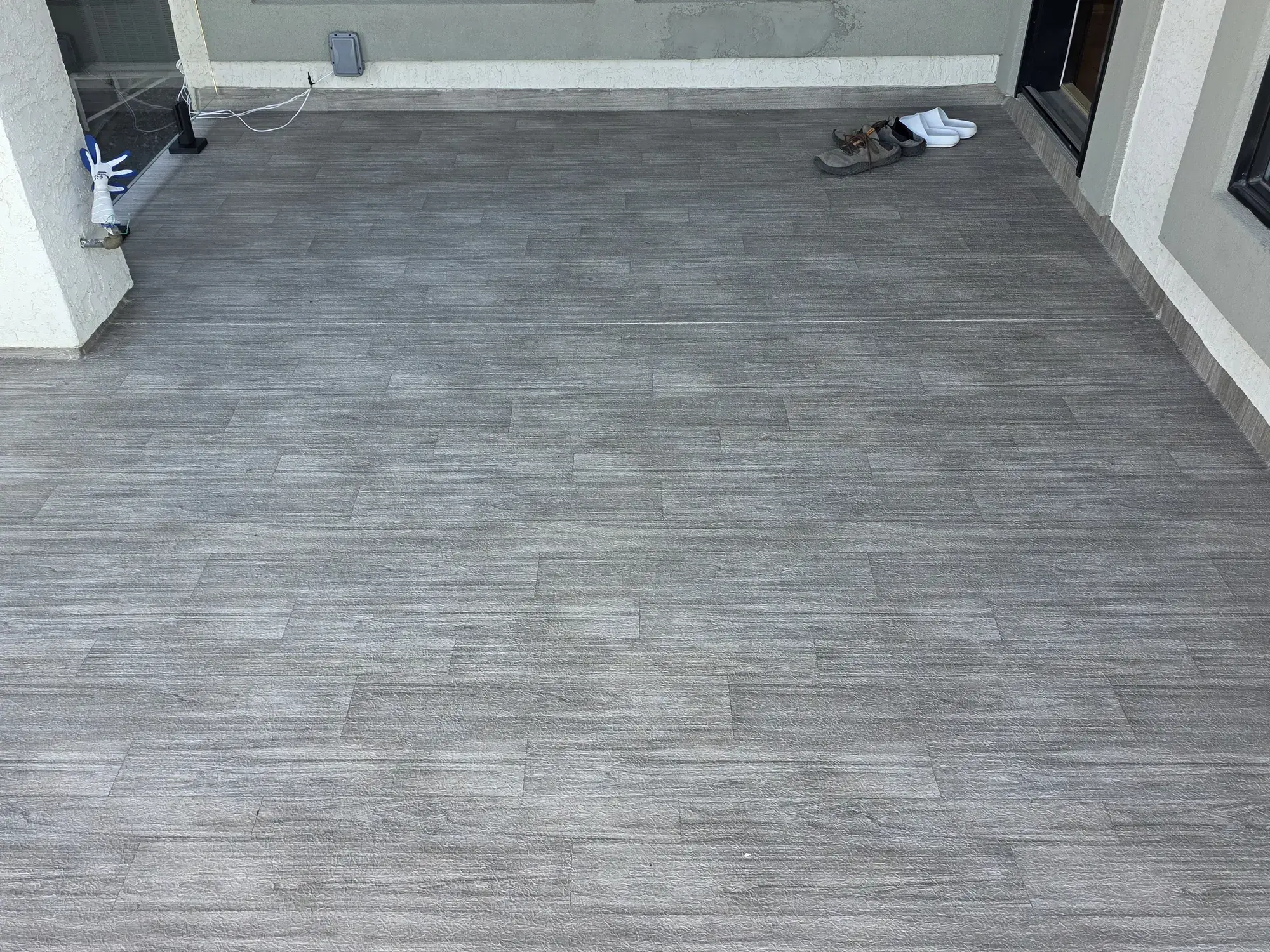 A woodgrain vinyl surface running between two walls of the house